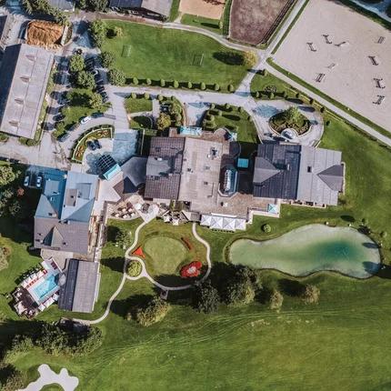 Hotel Gut Weissenhof © Gut Weissenhof Luftaufnahme eines großen Gebäudekomplexes mit Teich und Gartenanlagen
